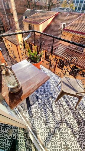 a patio with a table and chairs on a balcony at Old Town #Menorah #MostCity in Dnipro