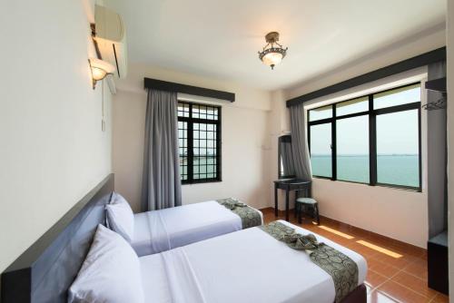 Postel nebo postele na pokoji v ubytování Glory Beach Resort