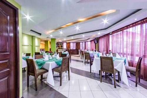 a restaurant with tables and chairs in a room at Hotel Rio in Nairobi