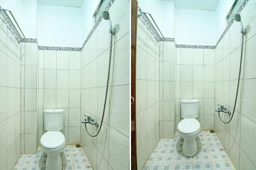 a bathroom with two toilets and a shower at OYO 91852 Prima Guesthouse Syariah in Padang