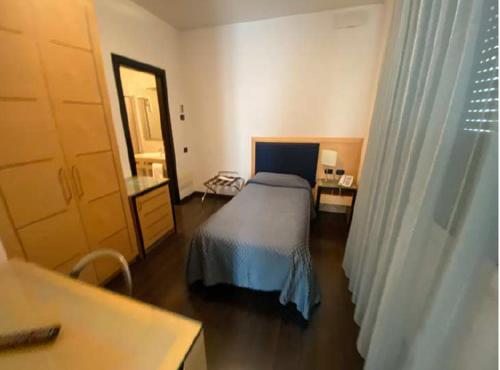 een slaapkamer met een bed, een tafel en een raam bij Luxury Rooms Padova Station in Padua