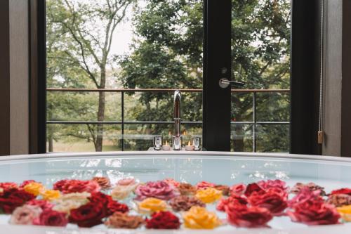 a glass tub filled with flowers in front of a window at Karuizawa Prince Hotel East in Karuizawa