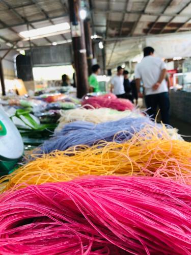 a pile of different colored yarns on a table at WELKOM INN in Can Tho