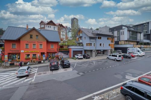 an aerial view of a city with cars parked on the street at Hotel Krokus in Pec pod Sněžkou
