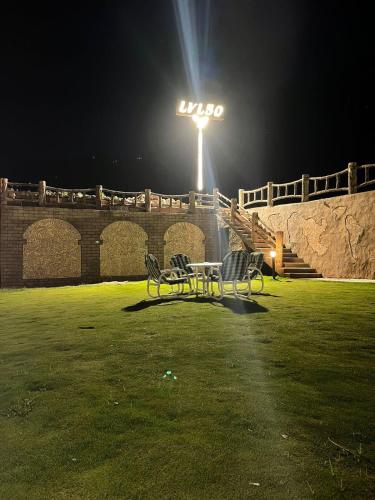 una mesa y sillas en un campo por la noche en LEVEL FIVE ZERO, en Murree
