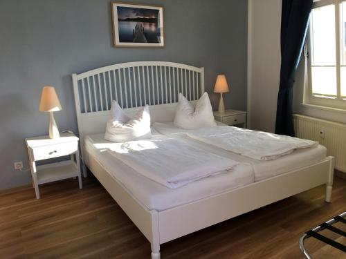 a bedroom with a white bed with pillows on it at Anna-App-10 in Ahlbeck