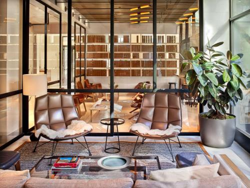 a living room with two chairs and a couch at Arlo SoHo in New York