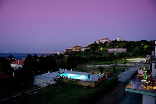 a view of a swimming pool at night at Appartamenti Pirrera in Patti