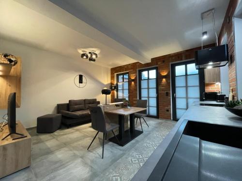 a living room with a table and a couch at Quartier 22 in Kurort Steinbach-Hallenberg