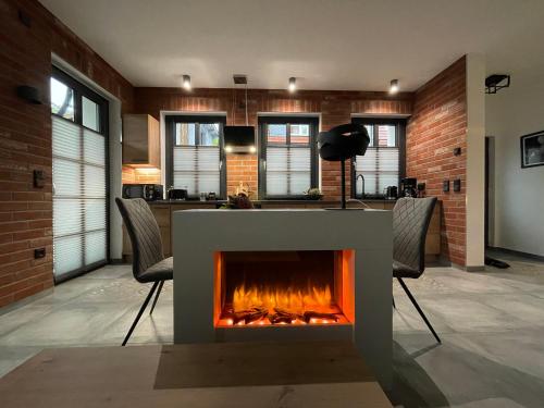 a kitchen with a fireplace in the middle of a room at Quartier 22 in Kurort Steinbach-Hallenberg