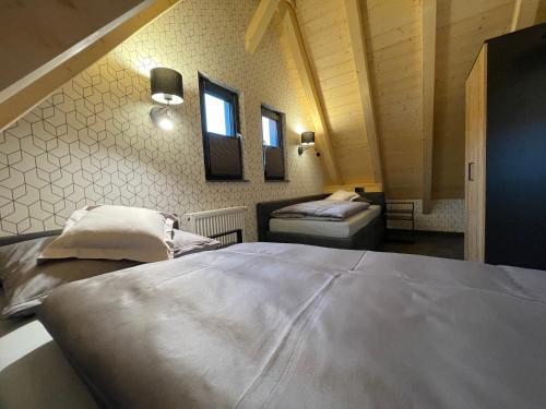 a bedroom with two beds and two windows at Quartier 22 in Kurort Steinbach-Hallenberg