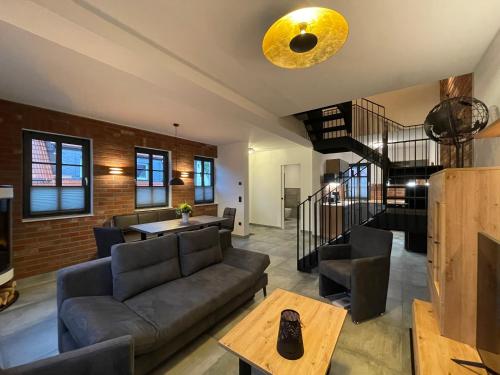 a living room with a couch and a table at Quartier 22 in Kurort Steinbach-Hallenberg