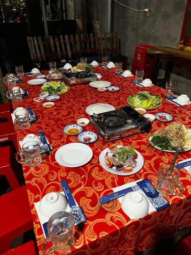 a long table with plates of food on it at Green Bamboo Lodge Resort in Cat Tien