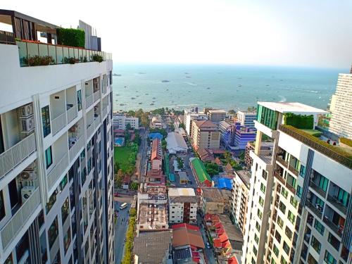 an aerial view of a city with buildings and the ocean at The Base Horizon Central Pattaya in Pattaya