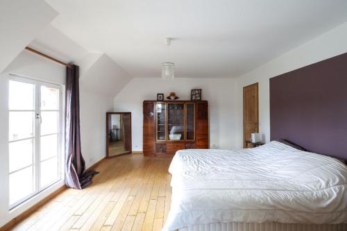 a bedroom with a large bed and a large window at LES DENISOTS 12/14 PERS PISCINE PRIVEE in Lavau
