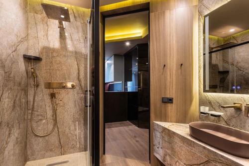 a bathroom with a sink and a shower with a shower at Luxury apartment in the superb location in Chişinău