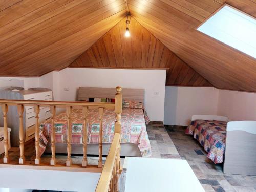 a attic bedroom with a bed and a skylight at Casa ORI in Perledo