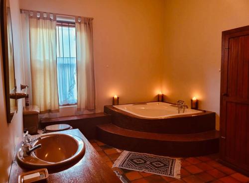 a bathroom with a large tub and a sink at Elizabeth's Cottage in Montagu