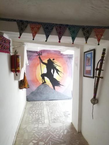 a painting of a witch on a wall in a hallway at Shiva Guest House in Pushkar