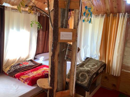 a room with two bunk beds in a cabin at RRR COTTAGES AND TREE HOUSE BY WB RESORTS in Banjār