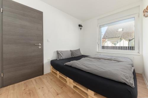 a bedroom with a bed and a large window at Apartments Rok in Ljubljana