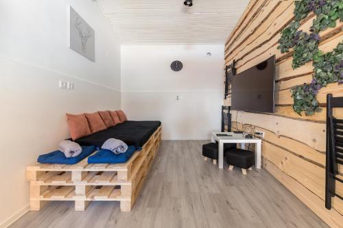 a room with a bed and a flat screen tv at Apartments Keber in Ljubljana