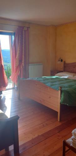 a bedroom with a large bed and a window at Casale Trusella in Ponti