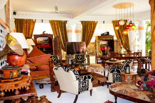 a living room filled with furniture and a tv at African House Resort in Malindi