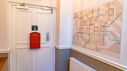 a red mail box next to a door with a map at Chelsea Guest House in London
