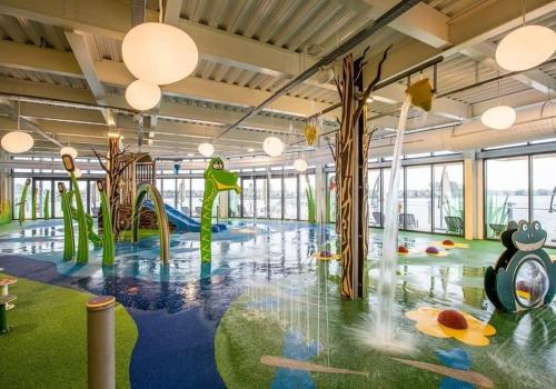 a large room with a playground with a slide at Living Easy Staycations at Tattershall Lakes in Tattershall