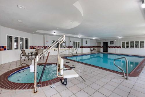 a large swimming pool with a slide in a building at Quality Inn & Suites I-35 E-Walnut Hill in Dallas