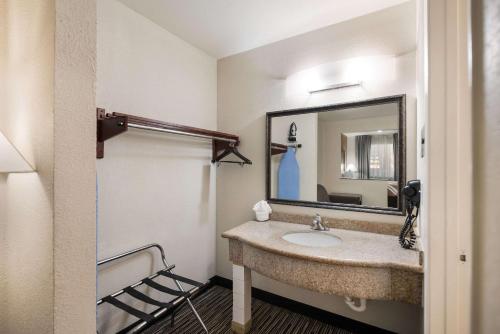 a bathroom with a sink and a mirror at Quality Inn & Suites Lufkin in Lufkin
