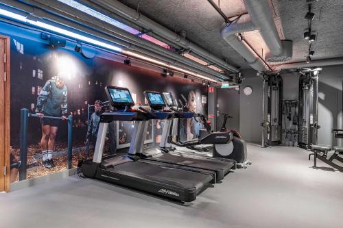 a gym with several treadmills and cardio machines at Best Western and Hotel Linkoping in Linköping