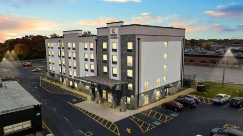 a large building with a parking lot in a parking lot at Comfort Suites St Louis - Sunset Hills in Saint Louis
