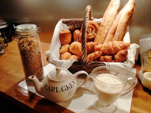 a basket of bread and pastries on a table at 14th Century Priory in Pressigny in Pressigny