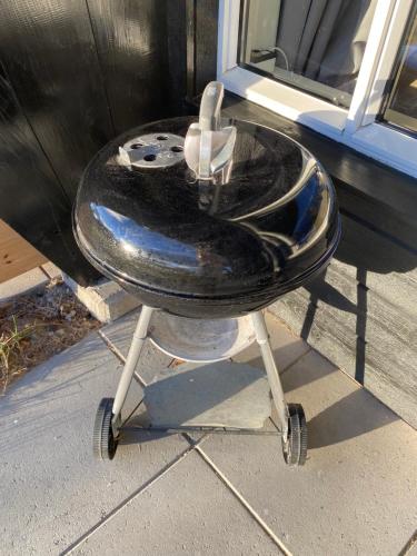 a bar stool with a table in front of a window at Leilighet Beitostølen sentrum, terrasse og innendørs parkering in Beitostøl
