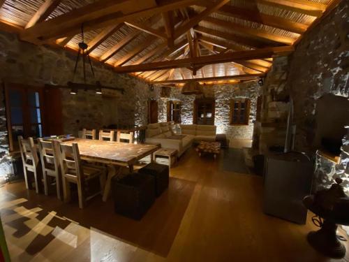 a large living room with a wooden table and chairs at Villa Ardamis Karyes in Karyes