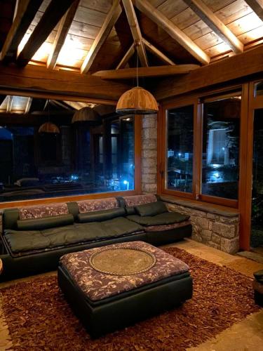 a living room with a couch and a table at Villa Ardamis Karyes in Karyes