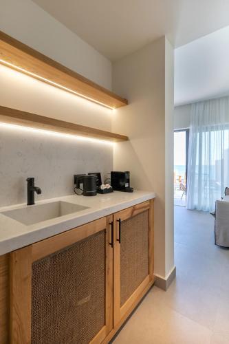 a kitchen with a sink and a living room at Bali Star Resort Hotel in Balíon