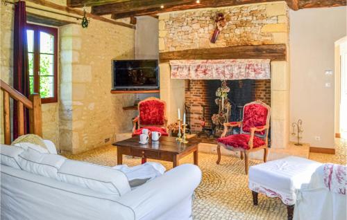 a living room with two white couches and a fireplace at Amazing Home In Fleurac in Fleurac