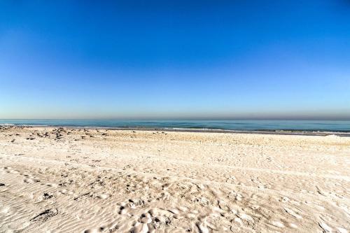 a beach with footprints in the sand and the ocean at Oceanfront Redington Shores Retreat Beach Access! in Clearwater Beach