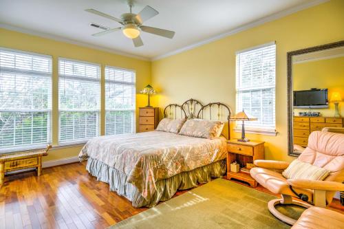 a bedroom with a bed and a chair and windows at Bethany Beach House 750 Feet from Ocean! in Bethany Beach