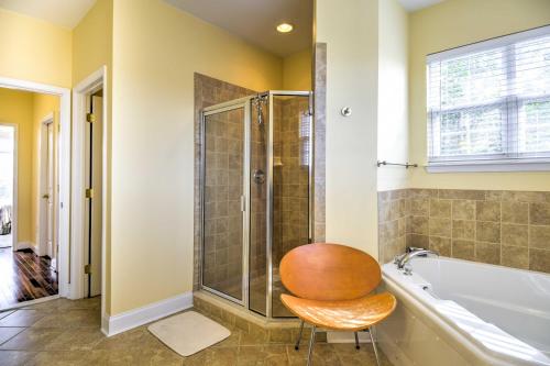 a bathroom with a chair next to a tub at Bethany Beach House 750 Feet from Ocean! in Bethany Beach