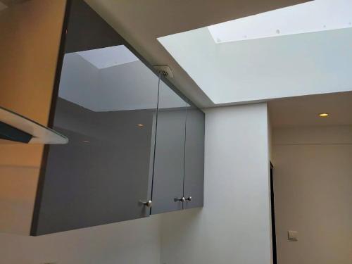 a kitchen with a large mirror on the ceiling at Chambres privatives avec espaces partagés dans maison Roubaix centre in Roubaix
