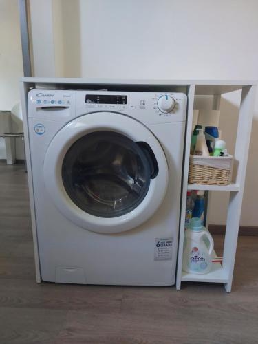 a washing machine with a shelf next to it at SPRING and SUMMER apartment near Ljubljana with FREE secure parking in Domžale