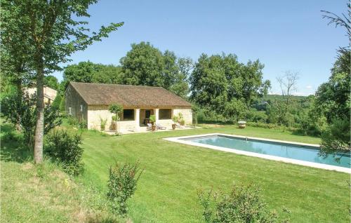 a stone house with a swimming pool in a yard at Nice Home In Domme With Wifi in Domme
