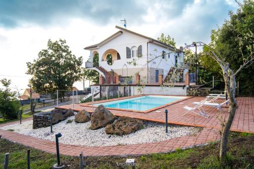 a house with a swimming pool in front of a house at Tenuta Carbone - Con piscina e parcheggio privato in Mascali