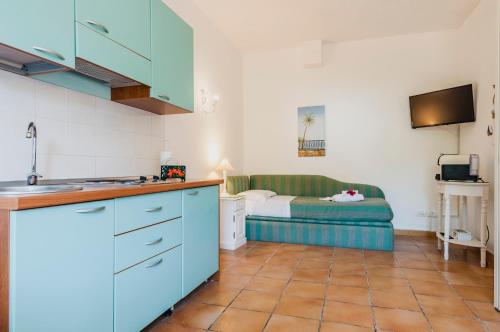 a kitchen and living room with a bed in the background at Calliope's Apartments - Stella del Mare in Siracusa