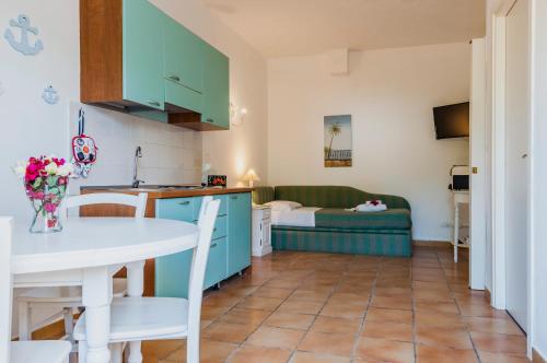 a kitchen and living room with a table and a couch at Calliope's Apartments - Stella del Mare in Siracusa