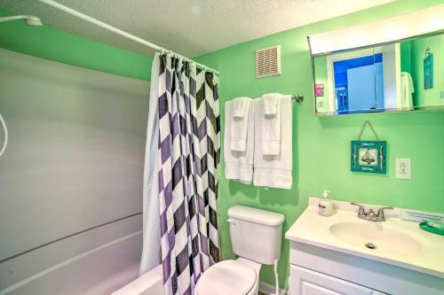 a green bathroom with a toilet and a sink at Coastal Atlantic Beach Duplex Less Than 1 Mi to Boardwalk! in Atlantic Beach